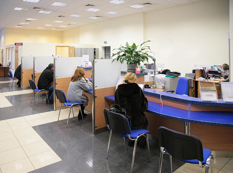 People sitting in bank before using bank security guards from SecureOne Inc.